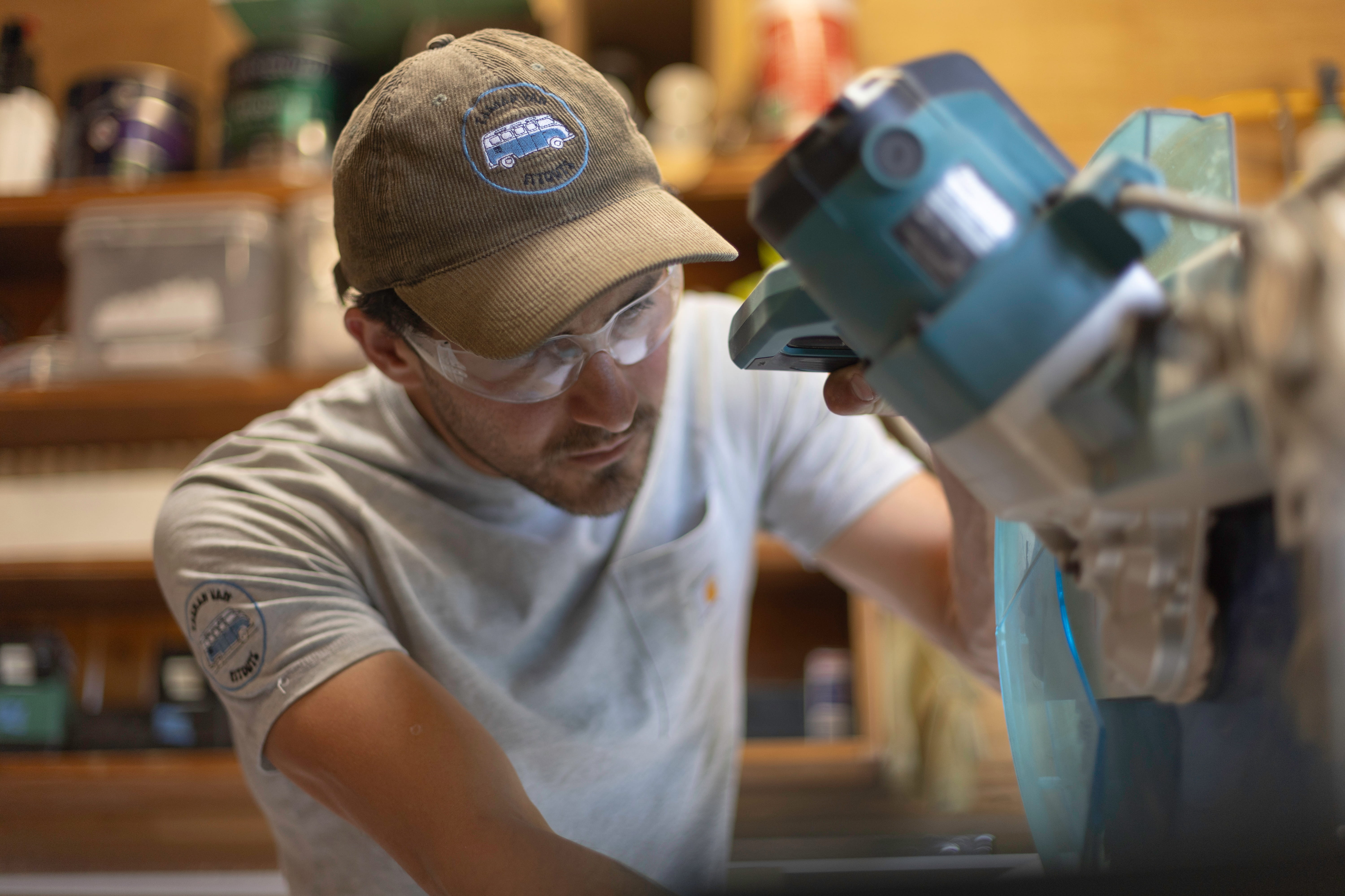 Harrison cutting timber in the workshop